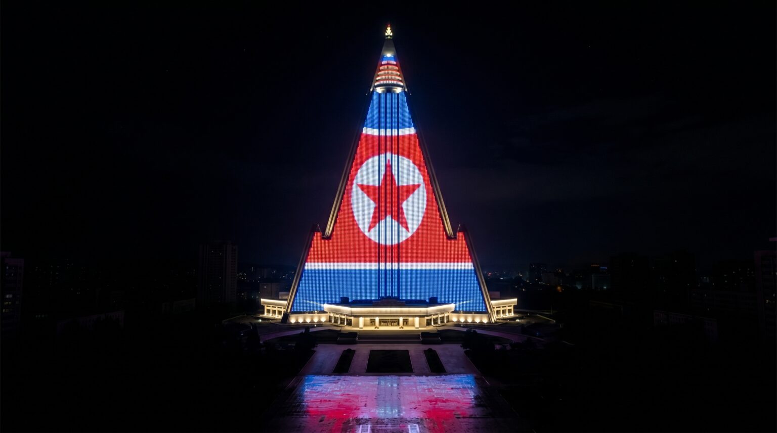 The Hotel of Doom illuminated at night with bright LED propaganda videos