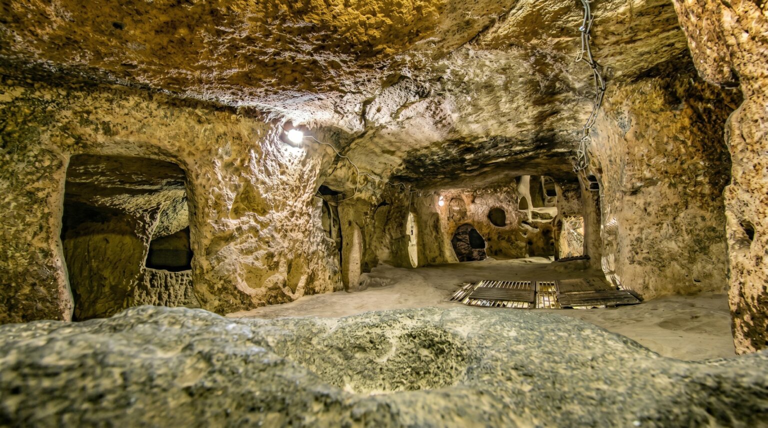 Ancient tunnel network inside Derinkuyu Underground City featuring carved rooms, narrow corridors, and centuries-old stone architecture